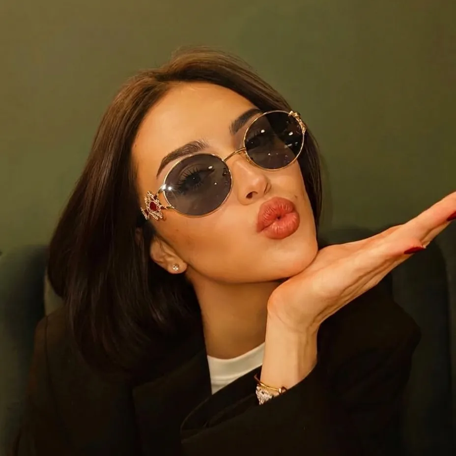 Eos Gold Black round metal sunglasses on model