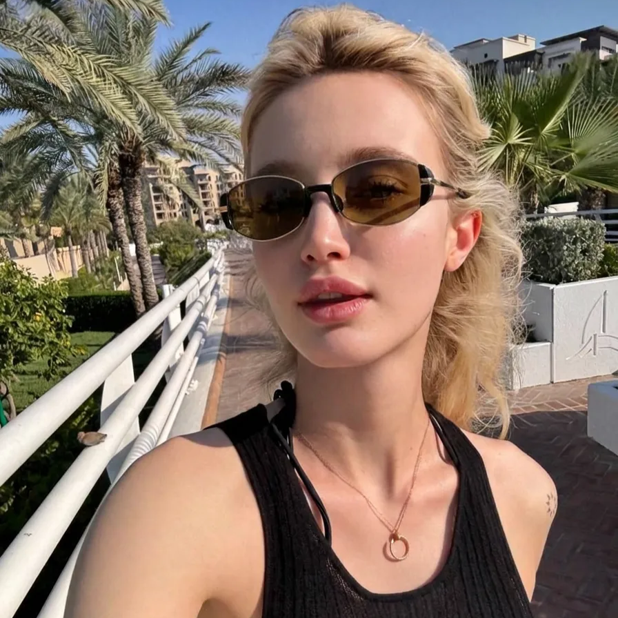Iris gold metal frame sunglasses with brown lenses worn by a model