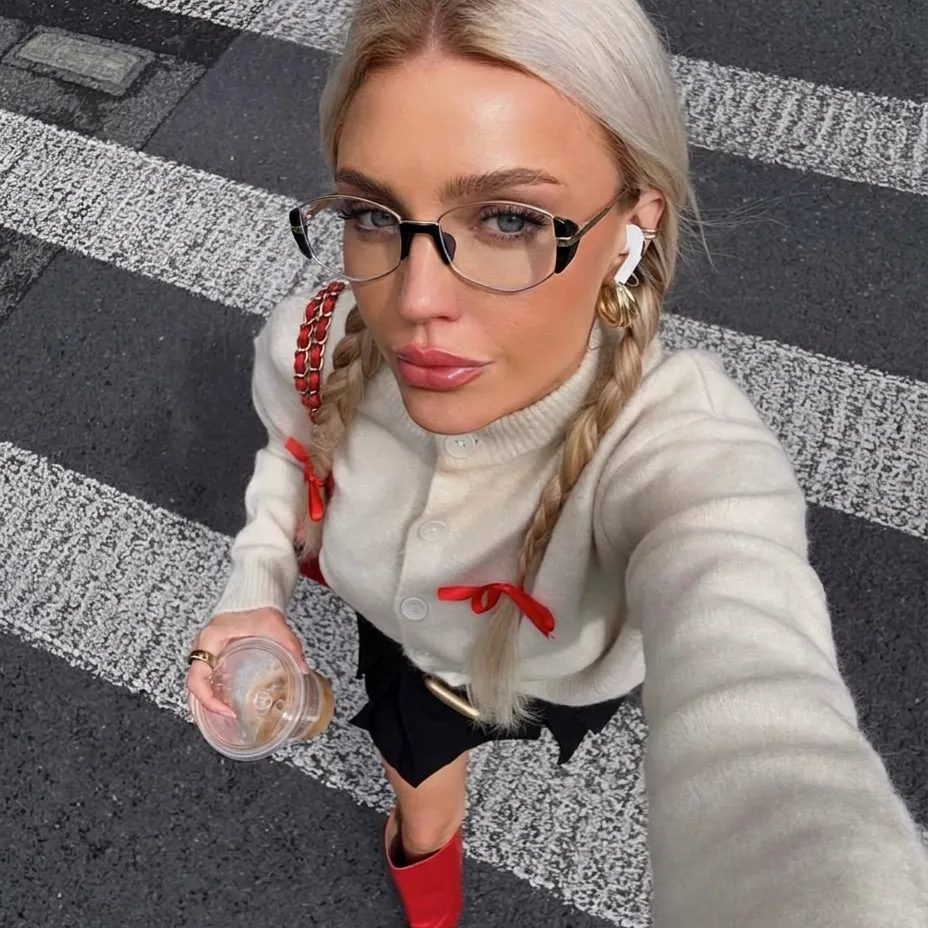 Iris gold metal frame eyewear with clear lenses worn by a model