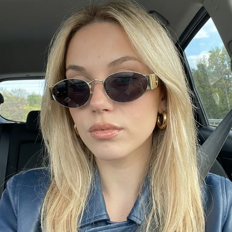 Zephyr Gold Black oval sunglasses on model